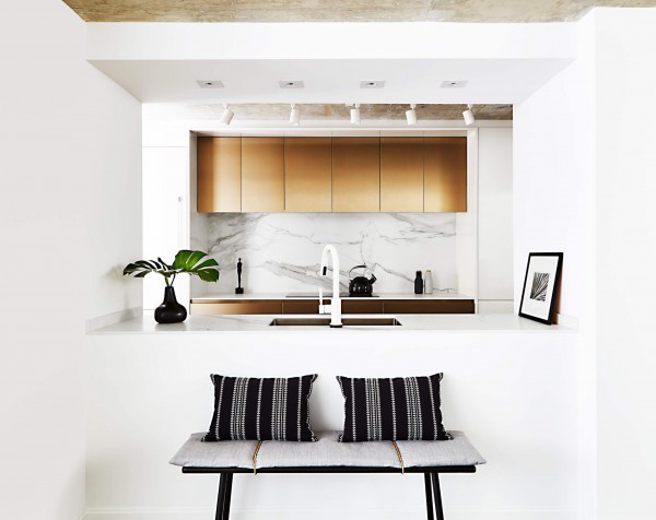 Kitchen with white walls, track lighting, white smart touch faucet, undermount sink, shiny metal cabinetry, marble countertop and wood bench Kitchen with white walls, track lighting, white smart touch faucet, undermount sink, shiny metal cabinetry, marble countertop and wood bench