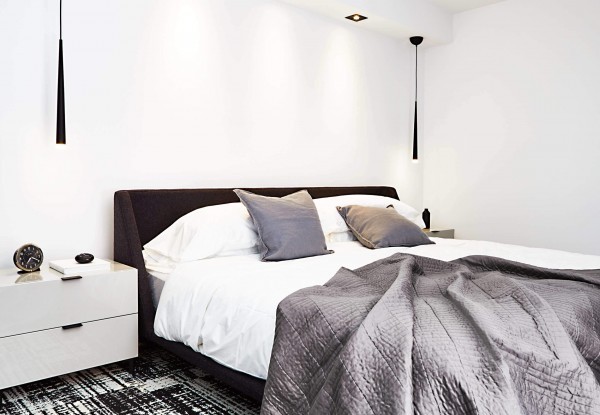 White bedroom with gray bed, black pendant lights, glossy gray night stands, white bedding, gray coverlet, and black and white carpet tiles White bedroom with gray bed, black pendant lights, glossy gray night stands, white bedding, gray coverlet, and black and white carpet tiles