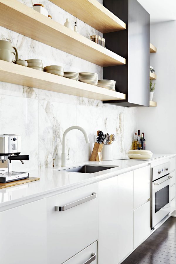 White kitchen cabinets, marble large scale blacksplash tile, dark metal hood fan, panel ready appliances, white range, white cooktop, white quartz counter top, limed oak open shelves, undermount sink, white faucet and dark hardwood floors White kitchen cabinets, marble large scale blacksplash tile, dark metal hood fan, panel ready appliances, white range, white cooktop, white quartz counter top, limed oak open shelves, undermount sink, white faucet and dark hardwood floors